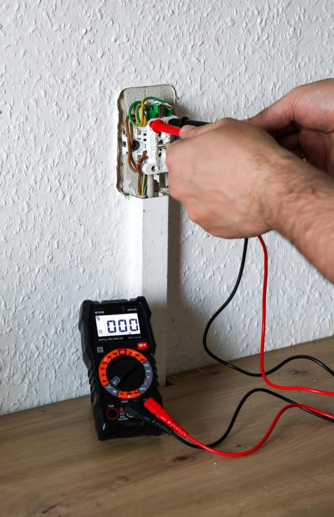 Professional electrician performing electrical inspection in a Midrand home.
