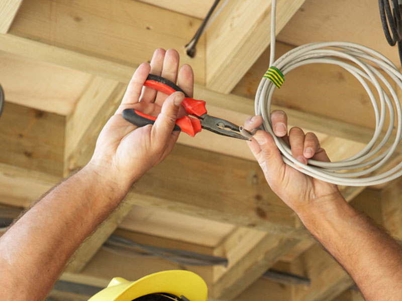 Electrician replacing old electrical wiring in a residential home